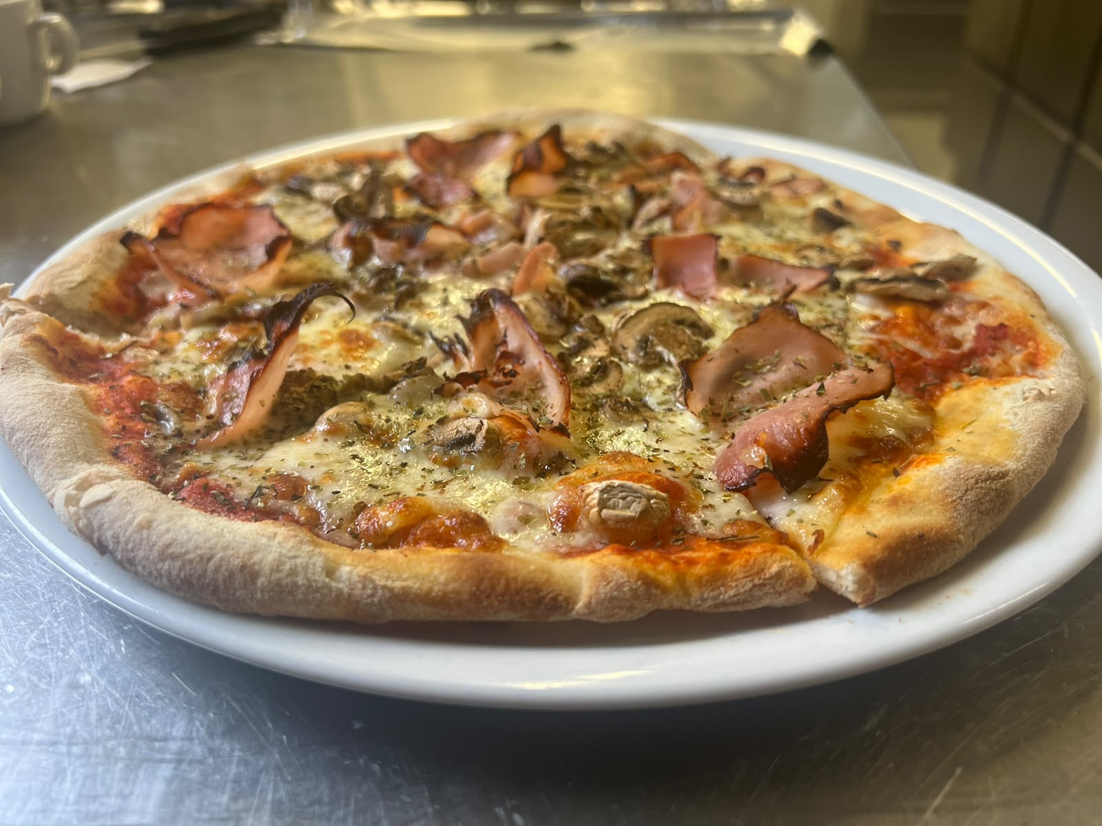 Freshly baked pizza representing the pizza menu